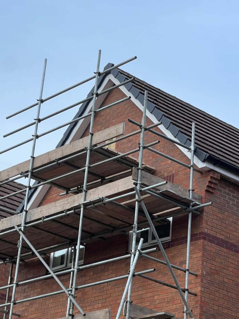 This is a photo of a roof which has just been repaired. There is a scaffold located at the gable end for access onto the roof. Works carried out by LJ Roofing Grove